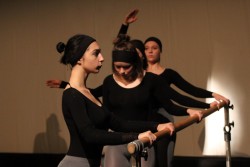 Zdjęcie przedstawia cztery tancerki wykonujące ćwiczenia przy drążku baletowym.